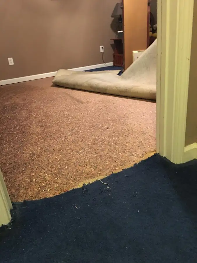 Carpet pad removal revealing water damage during Drying & Dehumidification in Hutchins