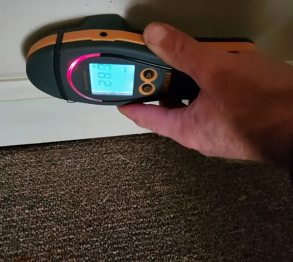 Moisture detection at baseboard during Storm Damage Restoration in Hutchins